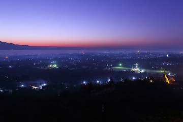 Fototapeta na wymiar Beautiful scenery during sunrise, Mountains mist of top view at Mandalay hill in Myanma