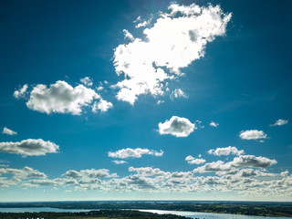 Obraz premium Bright blue sky with clouds above town in England Ipswich with Orwell bridge in background