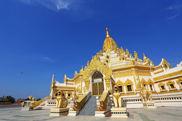Golden pagoda, Swe Taw Myat, Buddha Tooth Relic Pagoda at Yangon, Myanmar with blue sky background