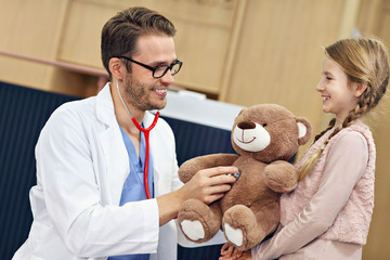 Doctor welcoming little girl in clinic