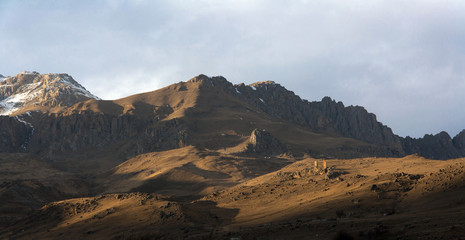 Mountain landscape, the old fortress stands in the mountains.