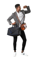 Naklejka premium Full body of African american business man traveling with suitcases celebrating a victory in winner position on white background