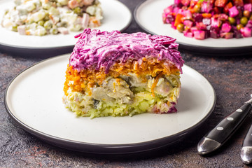 Russian food on dark background. Assortment salad of Russian cuisine - Olivier salad, vinaigrette - beet salad, herring salad. Top view. Copy space.