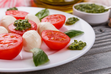 Caprese salad on a wooden rustic background