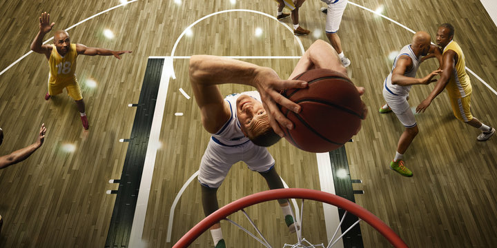 Basketball Players On Big Professional Arena During The Game. Basketball Player Makes Slum Dunk. Top View Through The Basketball Hoop