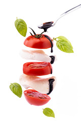 succulent Caprese salad with mozzarella cheese and tomato topped with a glaze of balsamic vinegar