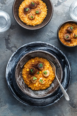 Pumpkin risotto in a table on stone background