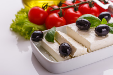 A piece of feta cheese on a white background
