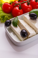 A piece of feta cheese on a white background