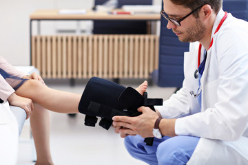 Little girl in clinic having a checkup with orthopaedist