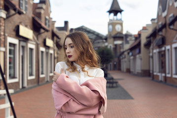 A girl is walking in the autumn in a European city