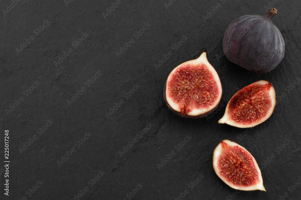 Wall mural fresh ripe figs on dark background, top view with copy space