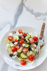 Greek salad on light background