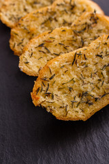 fragrant garlic bread on a dark stone plate