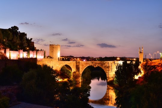 The Puerta de Alcantara on a bridge over the River Tagus with the Alcazar behind, Toledo, Castilla-La-Mancha, Spain