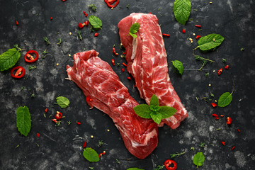 Raw lamb shoulder fillets with chilli, thyme and mint leaves