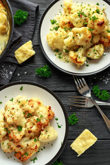 Roasted cauliflower with cheddar cheese sauce and herbs.
