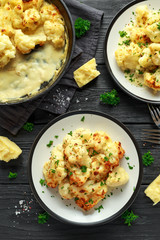 Roasted cauliflower with cheddar cheese sauce and herbs.