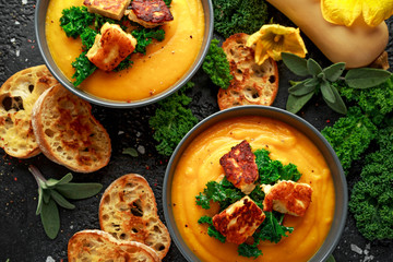 Baked butternut squash and carrot cream soup with steamed kale and fried halluomi
