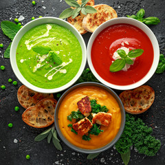 Variety of cream soup bowls: sweet pea and mint, tomato and basil and butternut squash with steamed kale and fried halluomi
