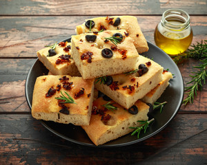 Homemade Italian focaccia with sun dried tomatoes, black olives and rosemary