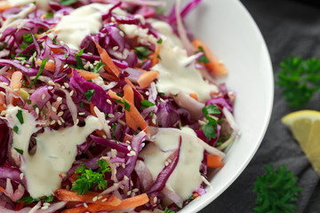 Coleslaw salad with red, white cabbage, carrot, parsley, sesame seeds. served with mayonnaise and lemon