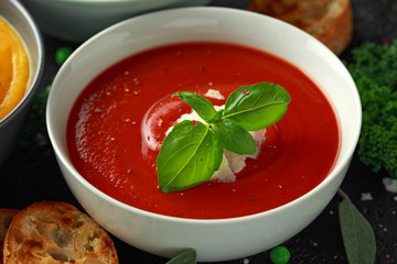 Tomato and fresh basil soup with garlic, cracked pepper corns, served with parmesan cheese, toast bread