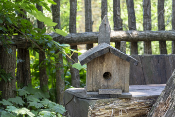 hand made  birds house wood lying on a table.