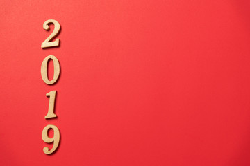 wood text year 2019 on red background for happy new year