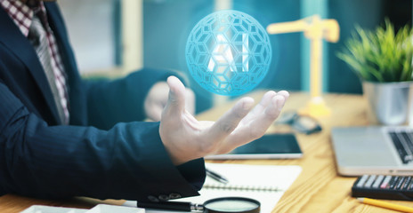 The abstract image young businessmenof hold the (AI)Artificial intelligence hologram on his hand and element of this image furnished the concept of (AI)Artificial intelligence , connection.