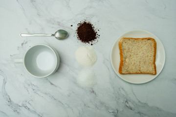 hot coffee and whole wheat bread on marble background