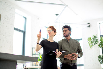 Two business people discussing about work in office