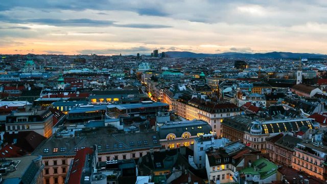 Vienna, Austria. Aerial view of Vienna, Austria in the evening with sunset sky. Illuminated historical buildings at night. Time-lapse, zoom in