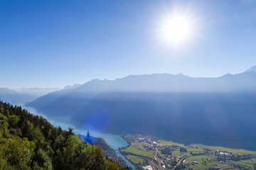 View over the city of Interlaken and the alps, mountains Eiger Moench and Jungfrau, lakes, the sun shinging brightly