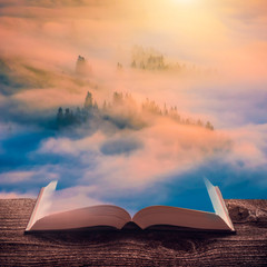 Majestic sunrise in a misty valley on the pages of book