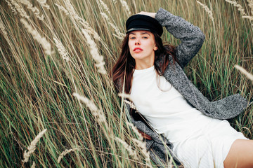 Young pretty brown-haired woman lying in the field