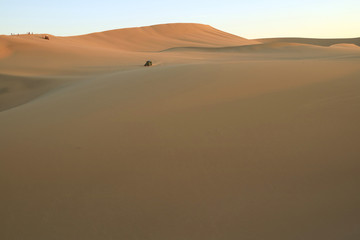 Fototapeta na wymiar People enjoy dune buggy on the immense desert of Huacachina, Ica, Peru, South America
