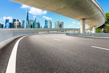 Empty asphalt road and modern city buildings with bridge in Shanghai
