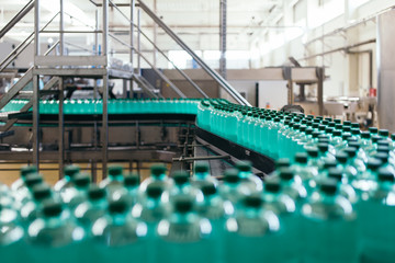 Obraz premium Industrial factory indoors and machinery. Robotic factory line for processing and bottling of pure spring water into canisters and bottles