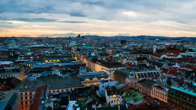 Vienna, Austria. Aerial view of Vienna, Austria in the evening with sunset sky. Illuminated historical buildings at night. Time-lapse
