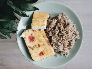 buckwheat and omelette on a round plate. green plate 