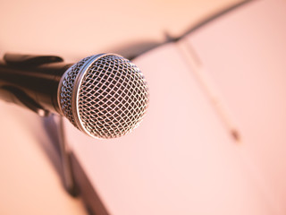 Microphone with notebook and pen with space. Press conference concept