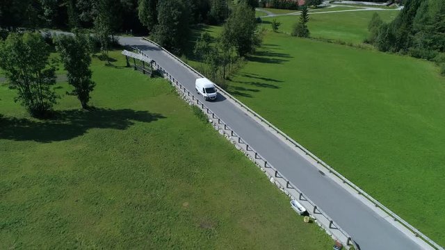 Aerial - High angle view of delivery van driving and transporting cargo