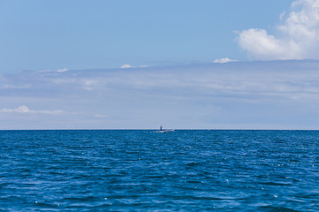 Fisherman in a small wooden boat