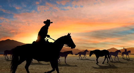 Cowboy leading horse herd © ginettigino