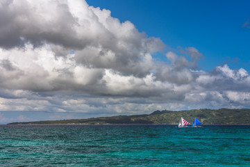 Obraz premium Two double outrigger sailboats on the sea