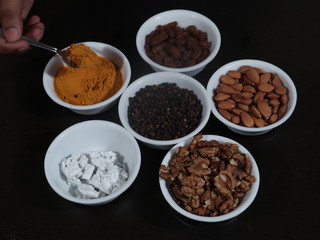 Turmeric, Kismish, Almonds, Badam, Akhrot, Walnuts, Chuna, Limestone, Haldi, Black Pepper, Kali Mirch, Wooden Background,