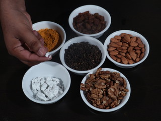 Turmeric, Kismish, Almonds, Badam, Akhrot, Walnuts, Chuna, Limestone, Haldi, Black Pepper, Kali Mirch, Wooden Background,