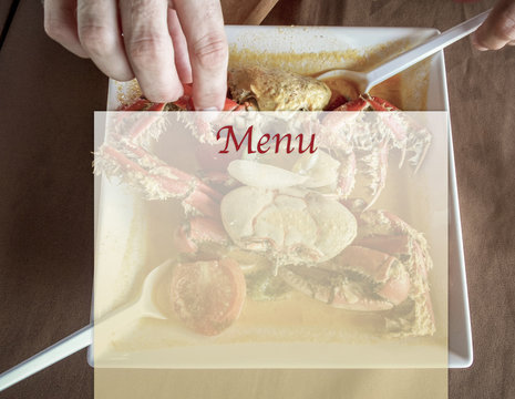 In the background a person degusting with hands a delicious tipical plate of crab with tomato and onion sauce and others spices in the Jacar&eacute; beach, in the city of Jo&atilde;o Pessoa, northeast Brazil. Conta