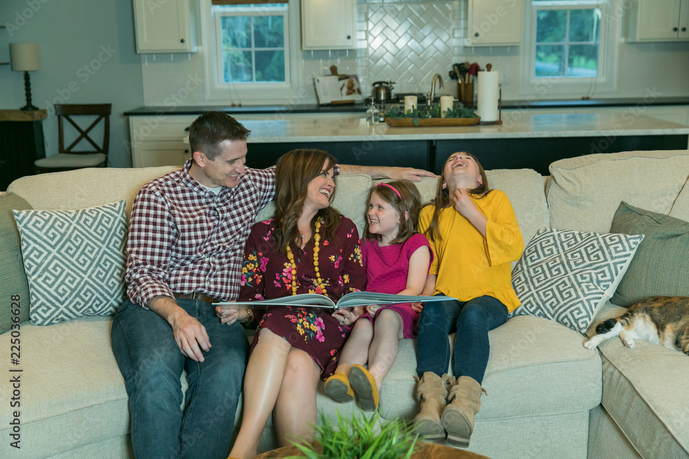 Wall mural mom dad and kids on the couch for family time